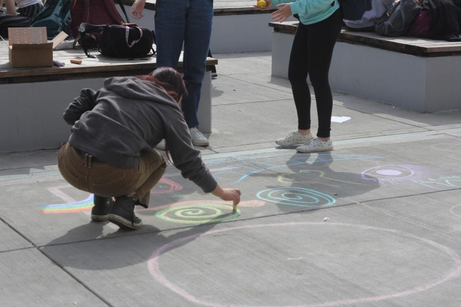 Senior Phebe Cox draws with chalk for a ROCK activity