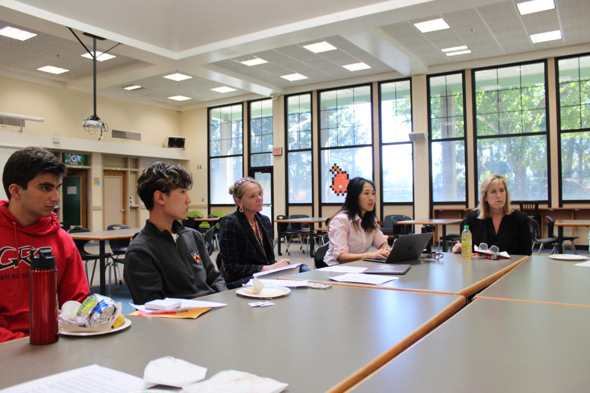 Gunn AI ad hoc committee members listen to educational AI policy proposals made by the district staff AI committee.